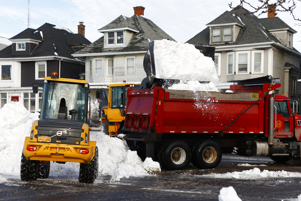 A front end loader dump snow into a dump truck as crews clear large amounts of snow in Buffalo, NY