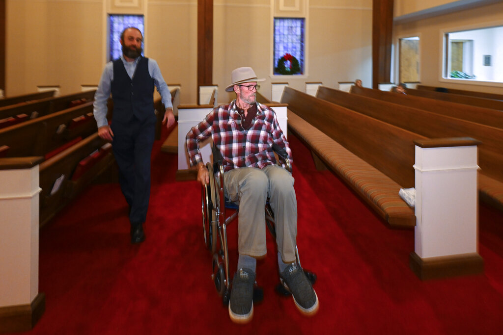 Jerry Lamb, who has a spine condition, talks to Pastor Adam Kelchner at Camden First United Methodist Church 