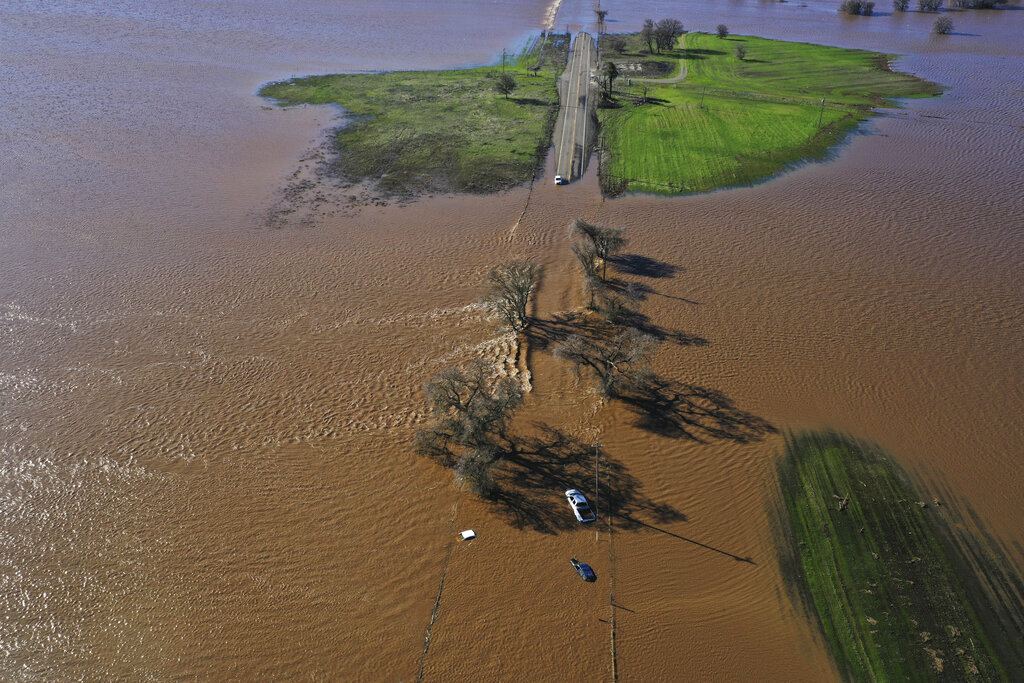 Three vehicles are submerged on roadway near Sacramento in flooding