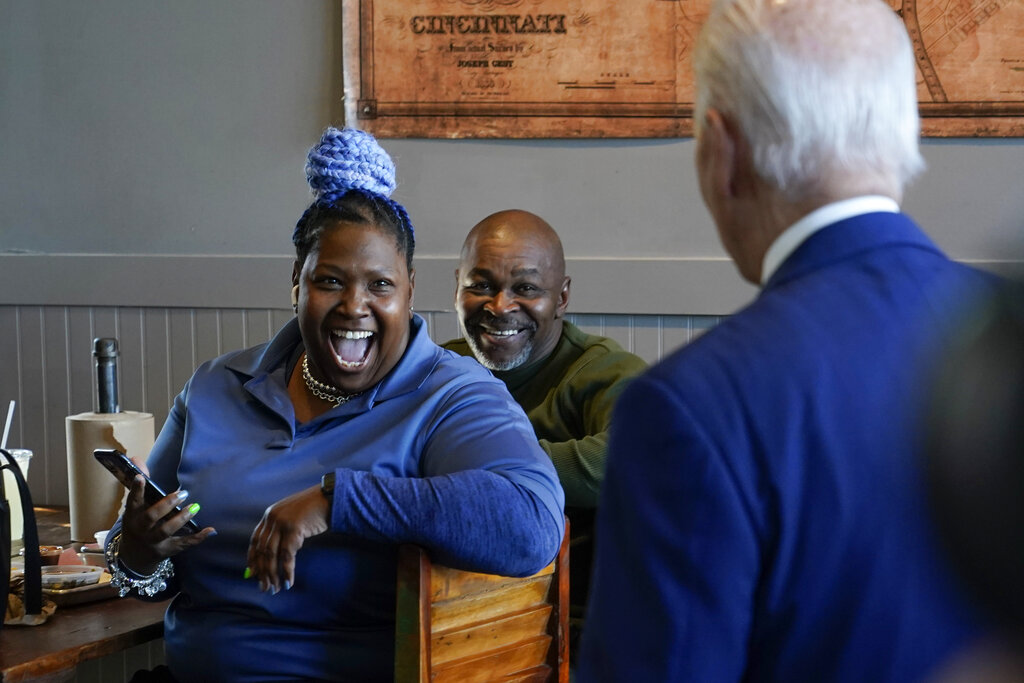 Customers react as President Joe Biden arrives at Just Q