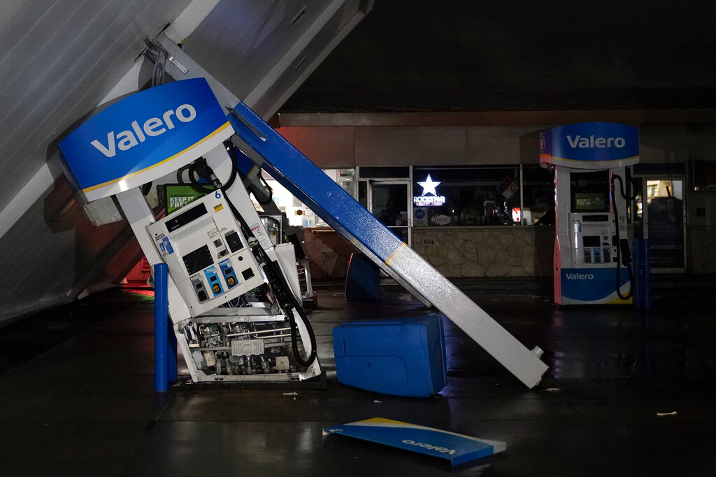 The canopy of gas station, toppled by strong winds, rests at an angle in South San Francisco