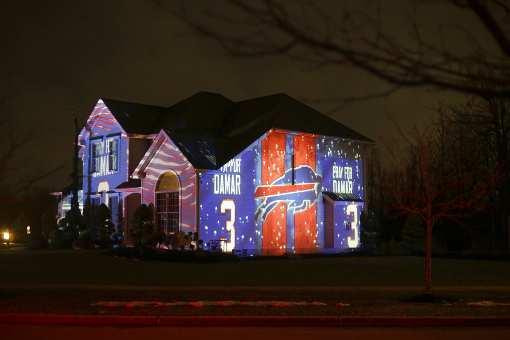 A projection showing support for Buffalo Bills safety Damar Hamlin is seen on Michael and Shauna Karas