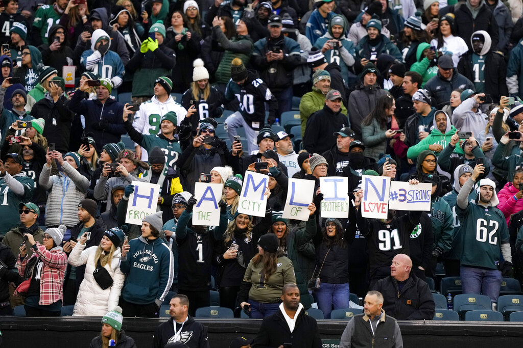 Spectators hold signs in honor of Buffalo Bills safety Damar Hamlin prior to an NFL football game between the Philadelphia Eagles and the New York Giants