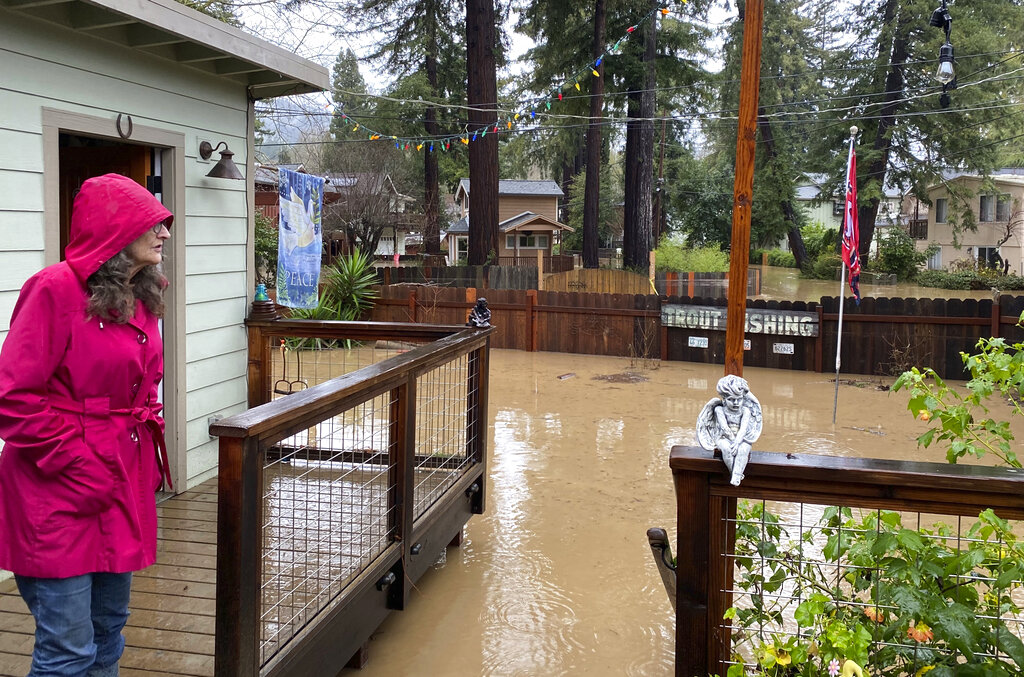 Linda Orengo surveys flood damage to her home in the Santa Cruz County town of Felton, Calif.