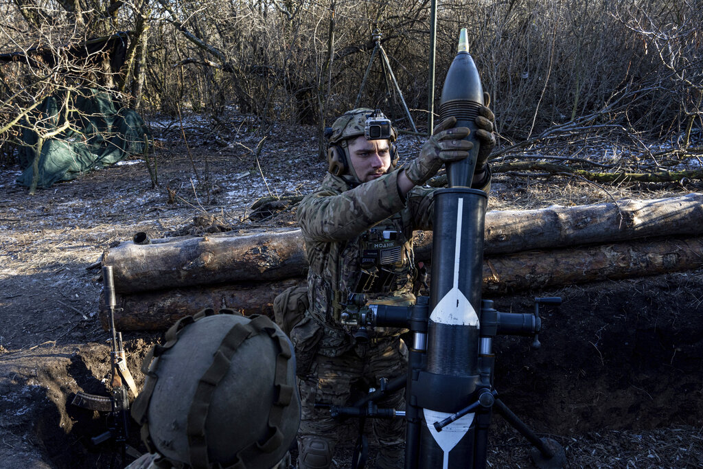 A Ukrainian serviceman prepares to fire a 120 mm mortar towards Russian positions at the frontline near Bakhmut, Donetsk region, Ukraine