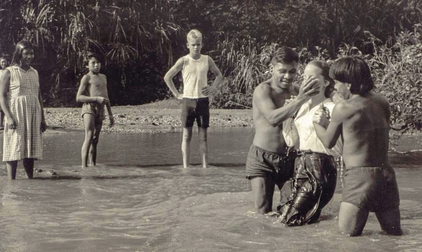 Kathy and Steve Saint, children of Nate Saint, baptized by members of the Huaorani tribe on Palm Beach where their father was murdered
