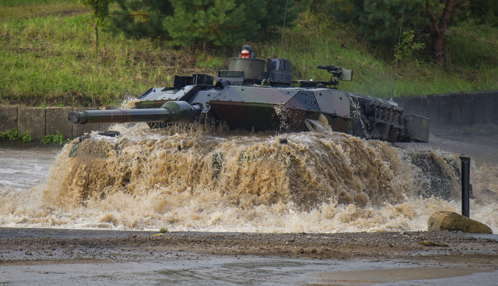 Leopard 2A6 main battle tank drives through a pool of water