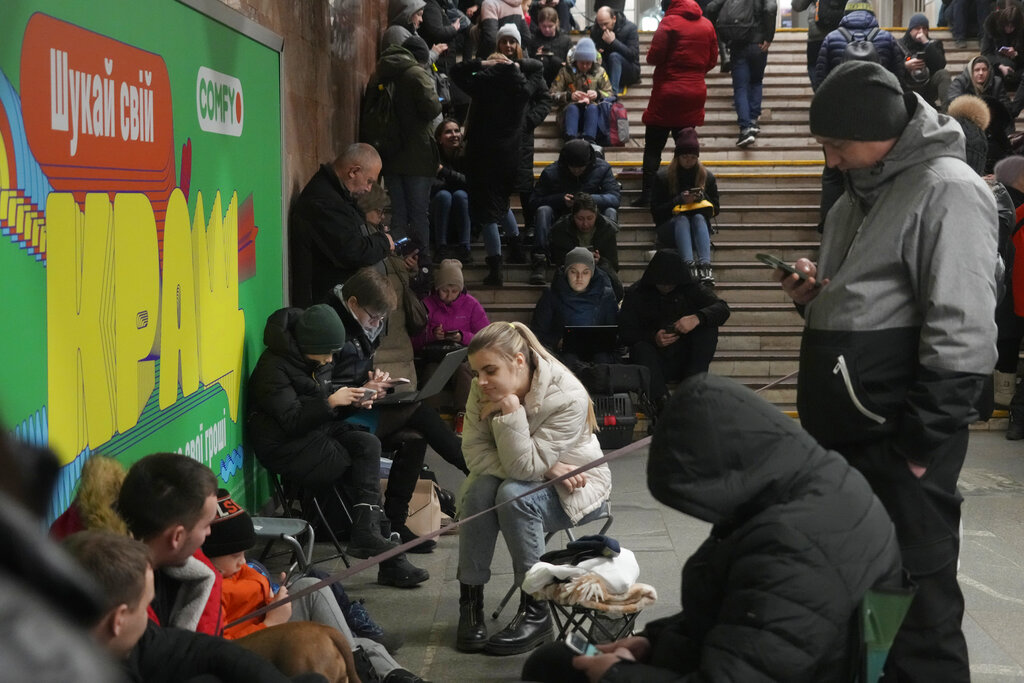 People gather in the subway station being used as a bomb shelter during a rocket attack in Kyiv, Ukraine