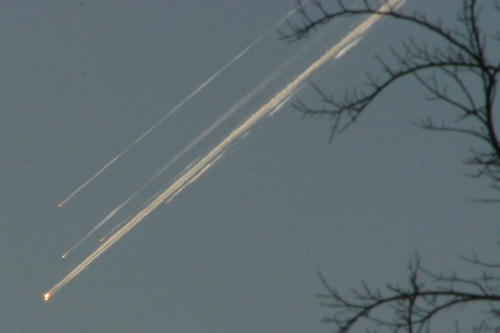 Debris from the space shuttle Columbia streaks across the Texas sky as seen from Dallas on Saturday, Feb. 1, 2003