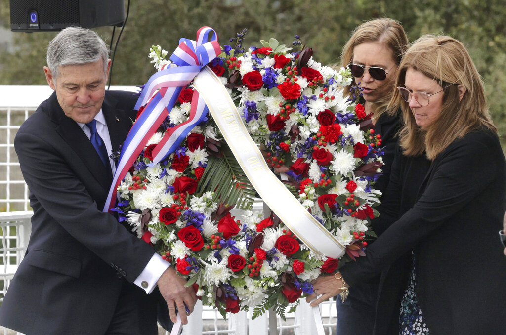 A wreath is presented by, from left, Bob Cabana, Associate Administrator of NASA; Janet Petro, NASA KSC director, and Sheryl Chaffee, daughter of Apollo 1 astronaut Roger Chaffee, during NASA