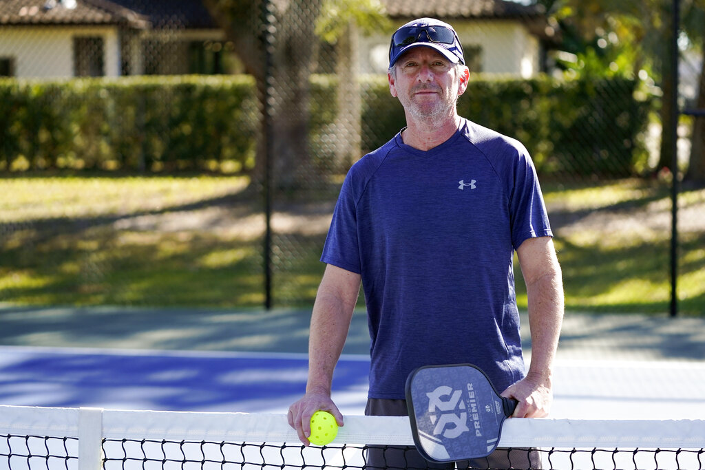 Owen Glick gets ready to play pickle ball at Phelps Park, Tuesday, Jan. 17, 2023, in Winter Park, Fla. Glick was among the 233,000 people who left a Western state for another U.S. state out of the region. The U.S. population center is on track this decade to take a southern swerve for the first time in history, and it's because of people like Glick, who moved from California to Florida more than a year ago. 