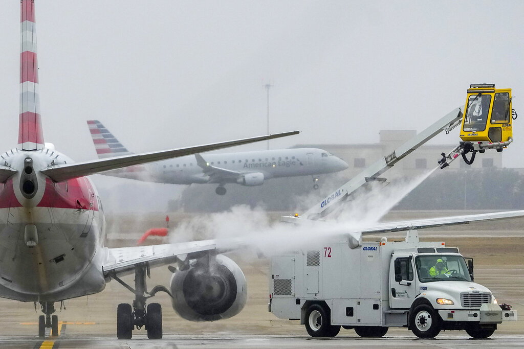 An American Airlines aircraft undergoes deicing procedures at Dallas/Fort Worth International Airport