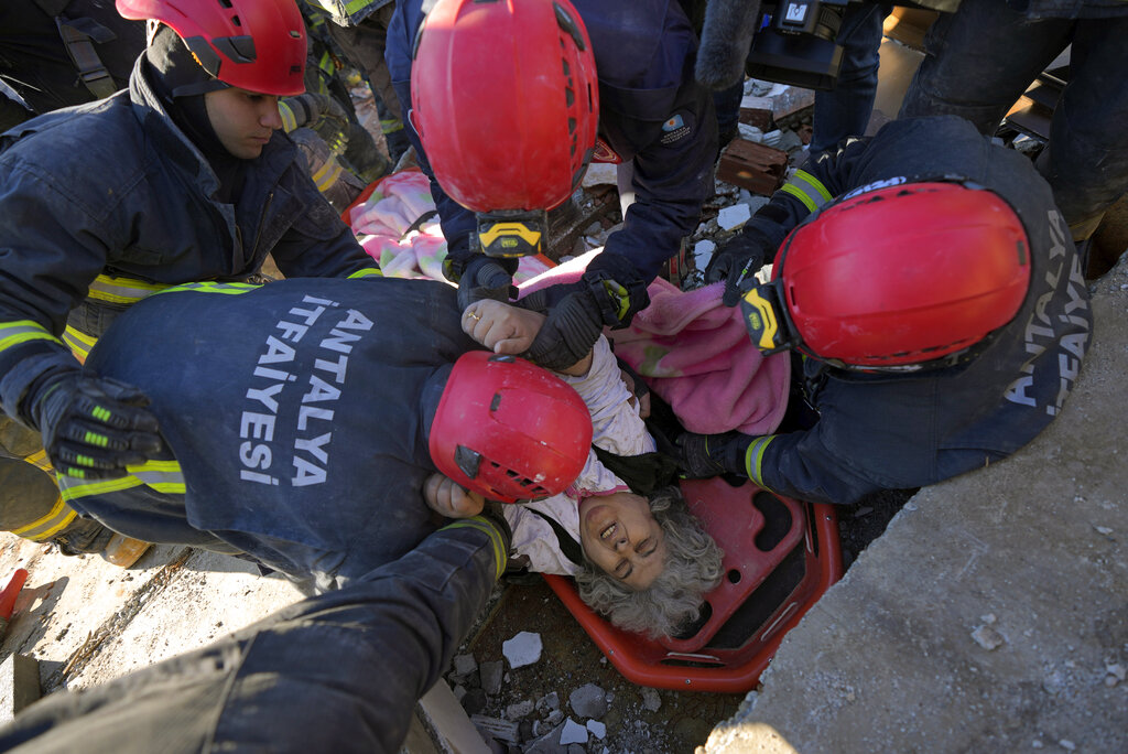 Rescue teams evacuate a survivor from the rubble of a destroyed building in Kahramanmaras, southern Turkey