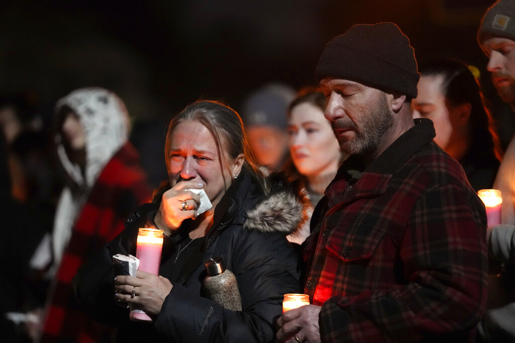 Mourners attend a candlelight vigil for Alexandria Verner at the Clawson High School football field in Clawson, Mich