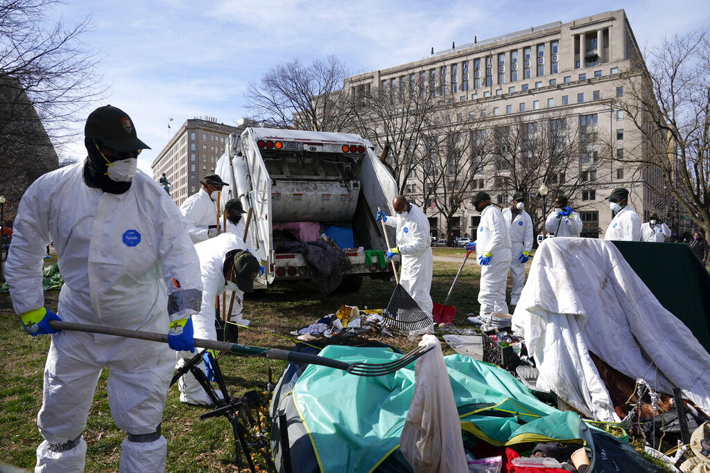 Workers clear a homeless encampment at McPherson Square in Washington,