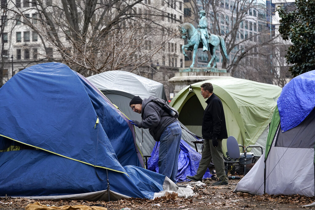 Homeless advocates check inside tents at McPherson Square