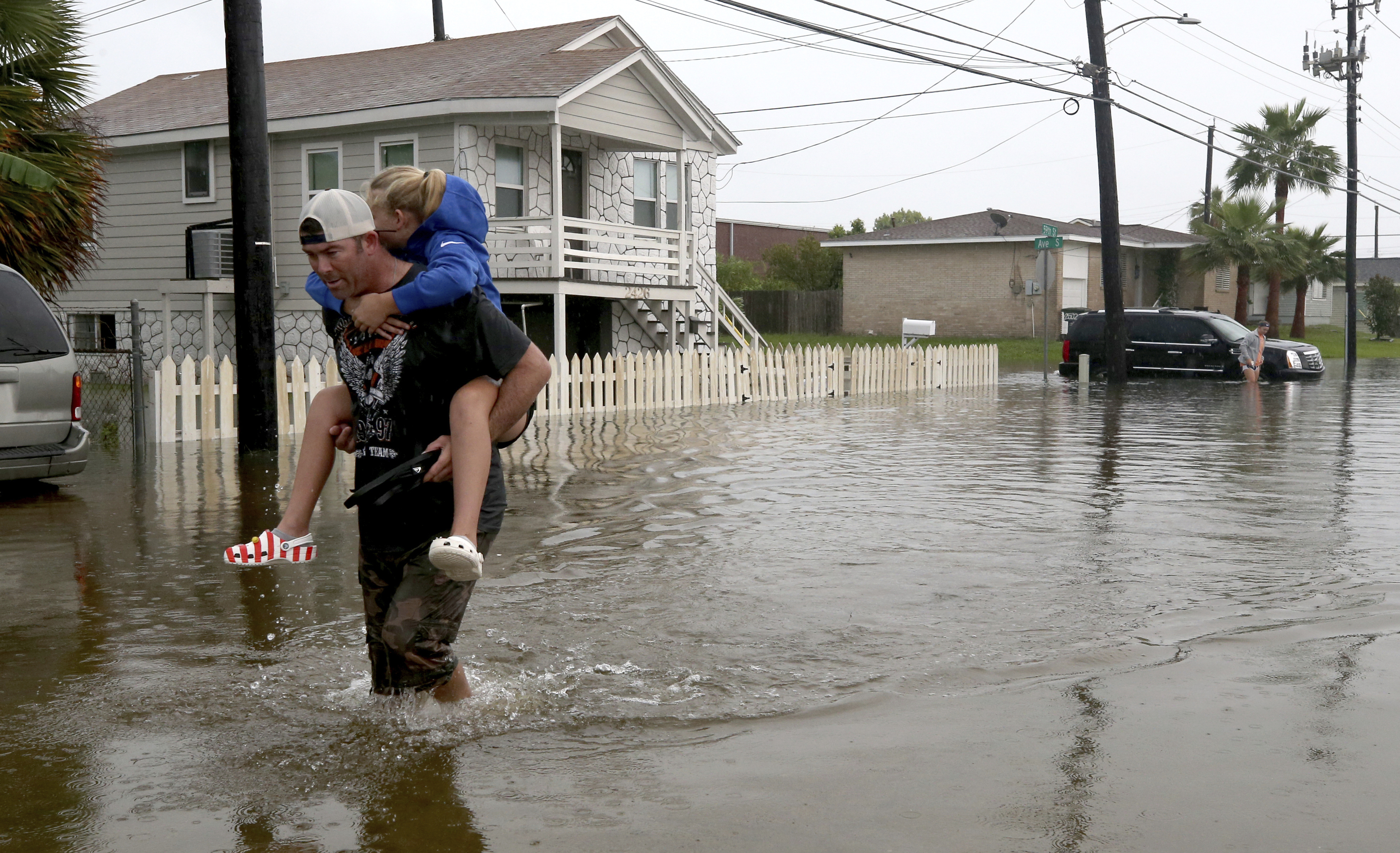 Dad carrying daughter in floodwaters, Galveston Texas