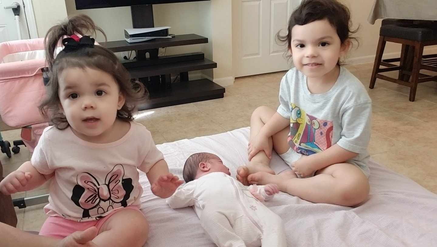 Jasmine and Jessica Turner with their baby sister Juliet. The Turner family has three girls all born on September 3 within four years.
