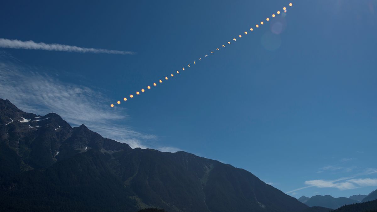 This composite image shows the progression of a partial solar eclipse over Ross Lake, in Northern Cascades National Park, Washington on Monday, Aug. 21, 2017.
