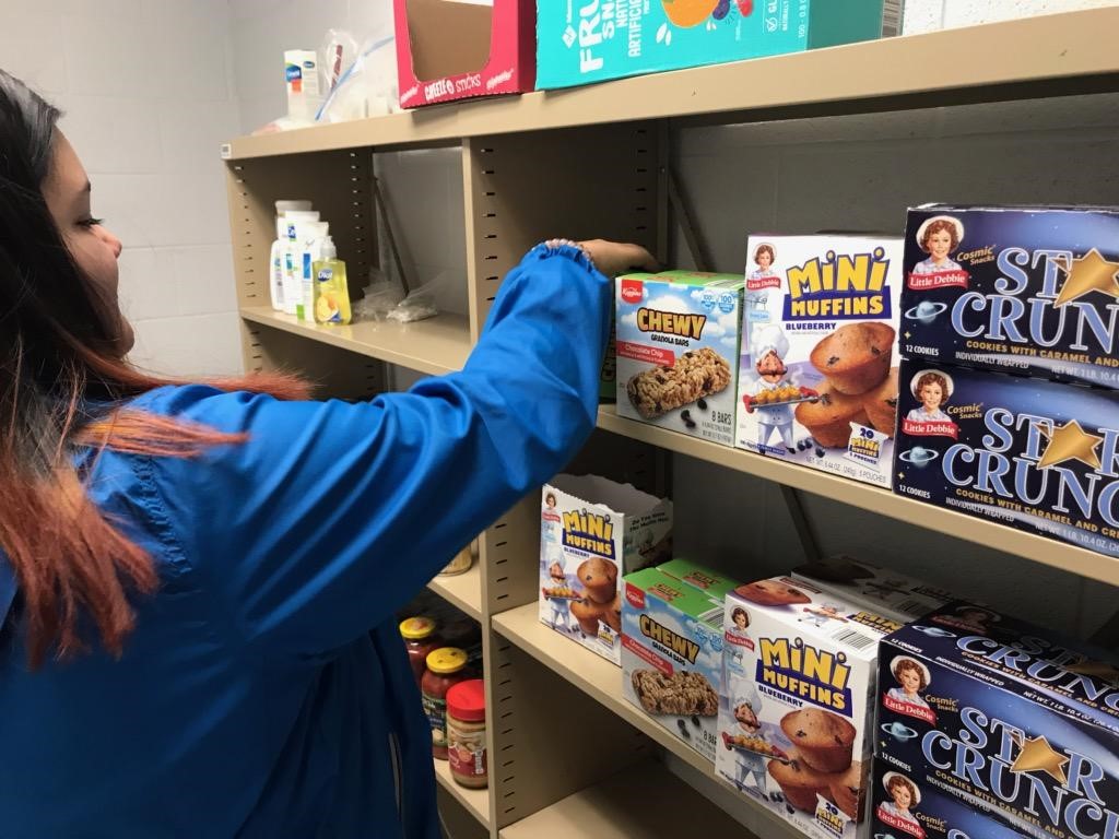 Person stocking student food pantry