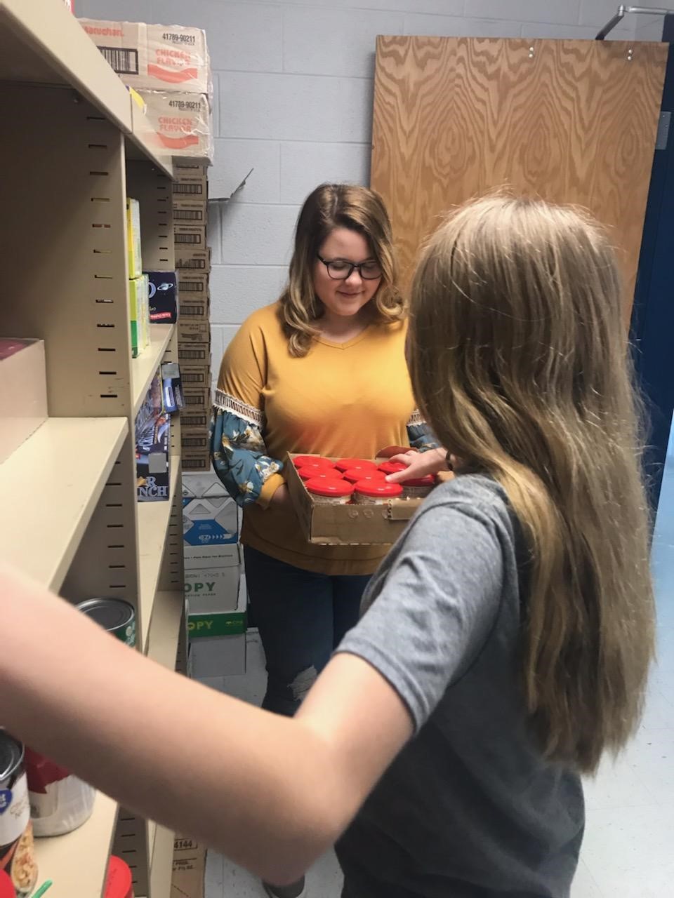 Students stocking school food pantry