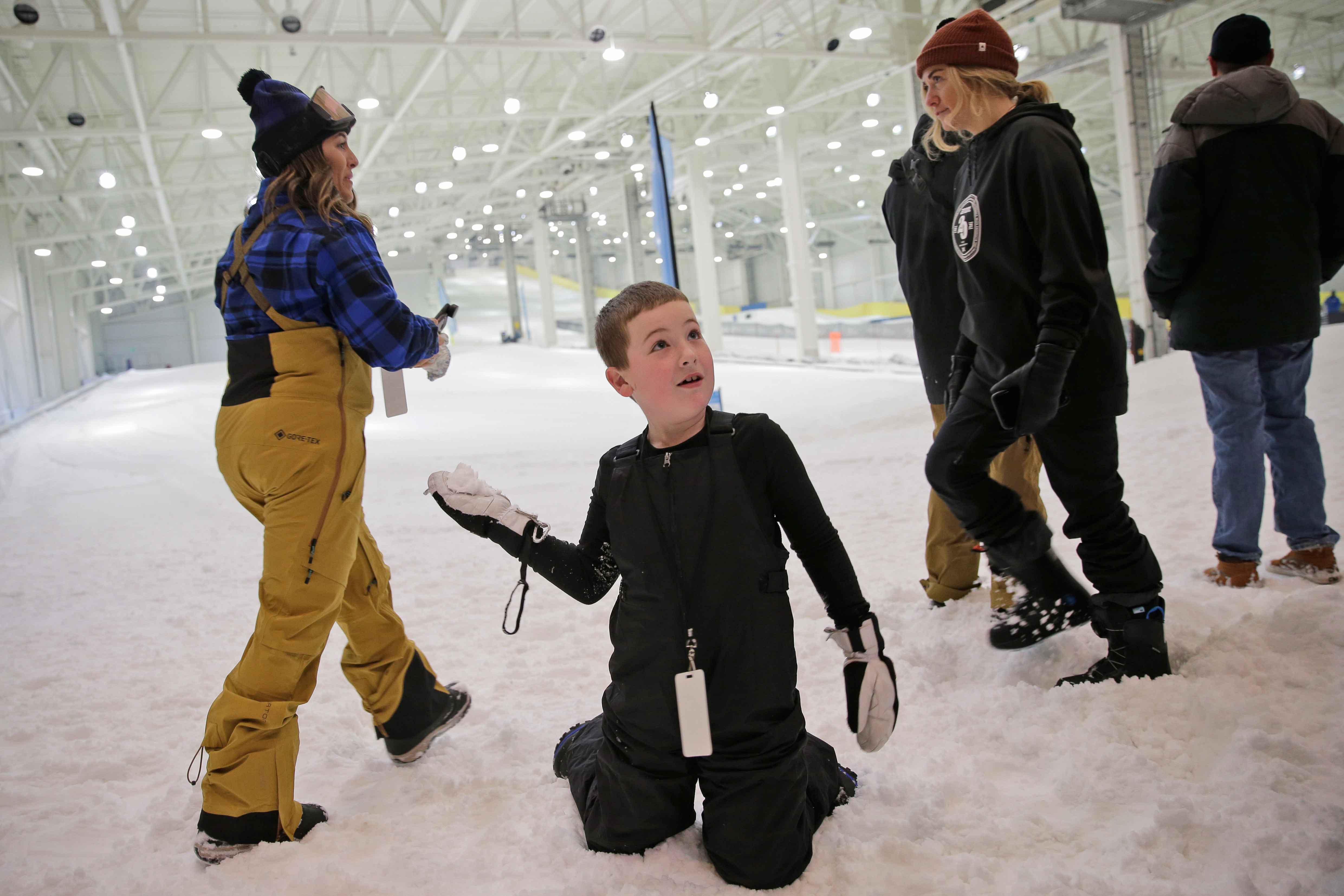 Kids playing in snow at indoor ski park