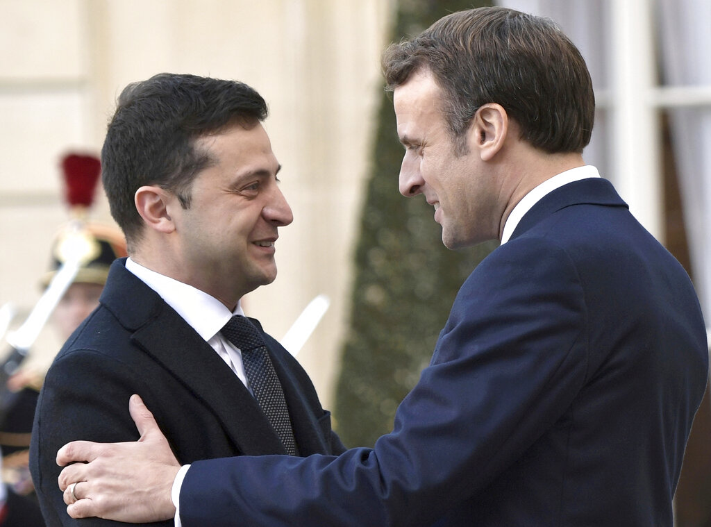 French President Emmanuel Macron, right, greets Ukrainian President Volodymyr Zelenskiy