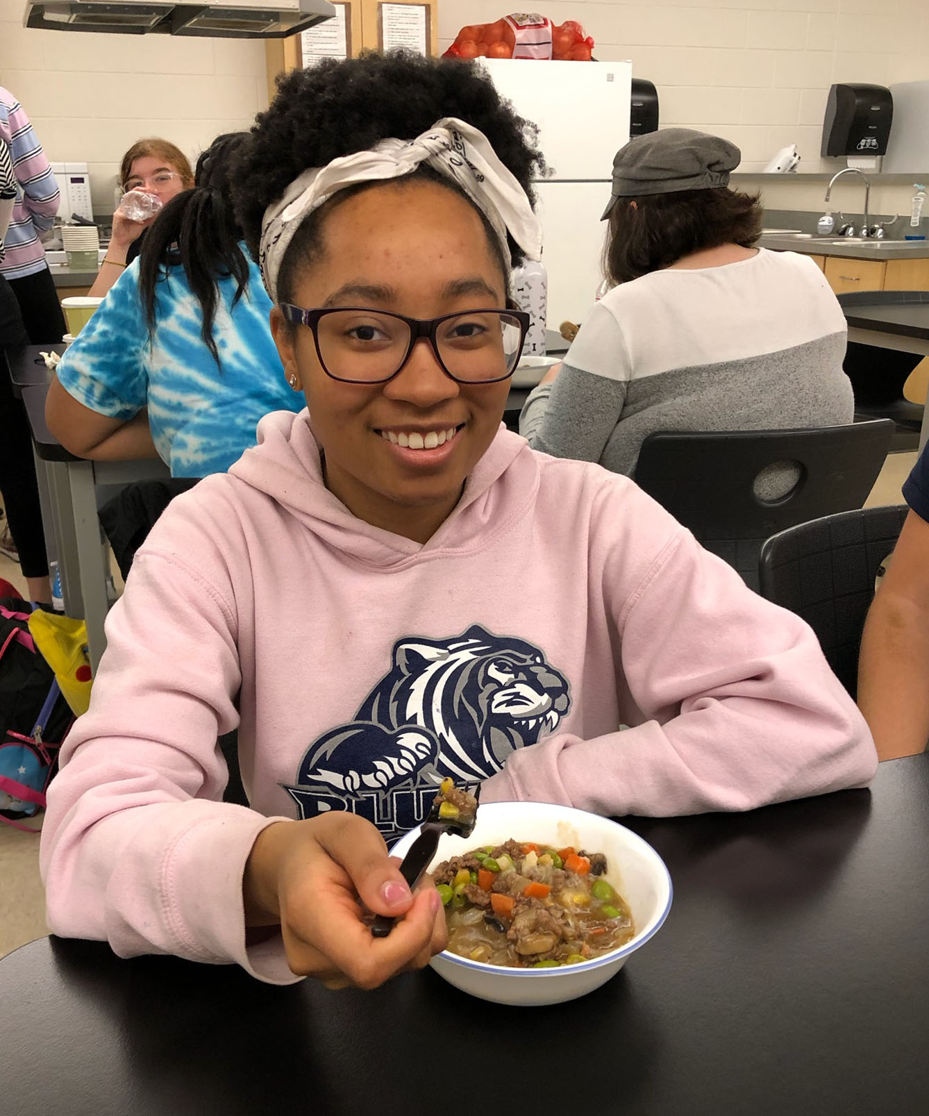 Student MiJah McQuitty enjoys her ramen after cooking the noodles, warming up and flavoring the broth, and prepping vegetables and protein to make her dish healthier.